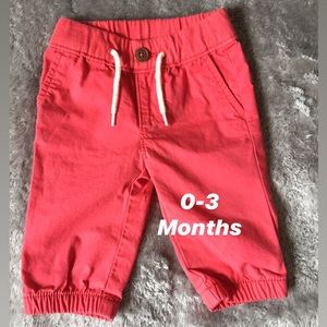 Red joggers with white string